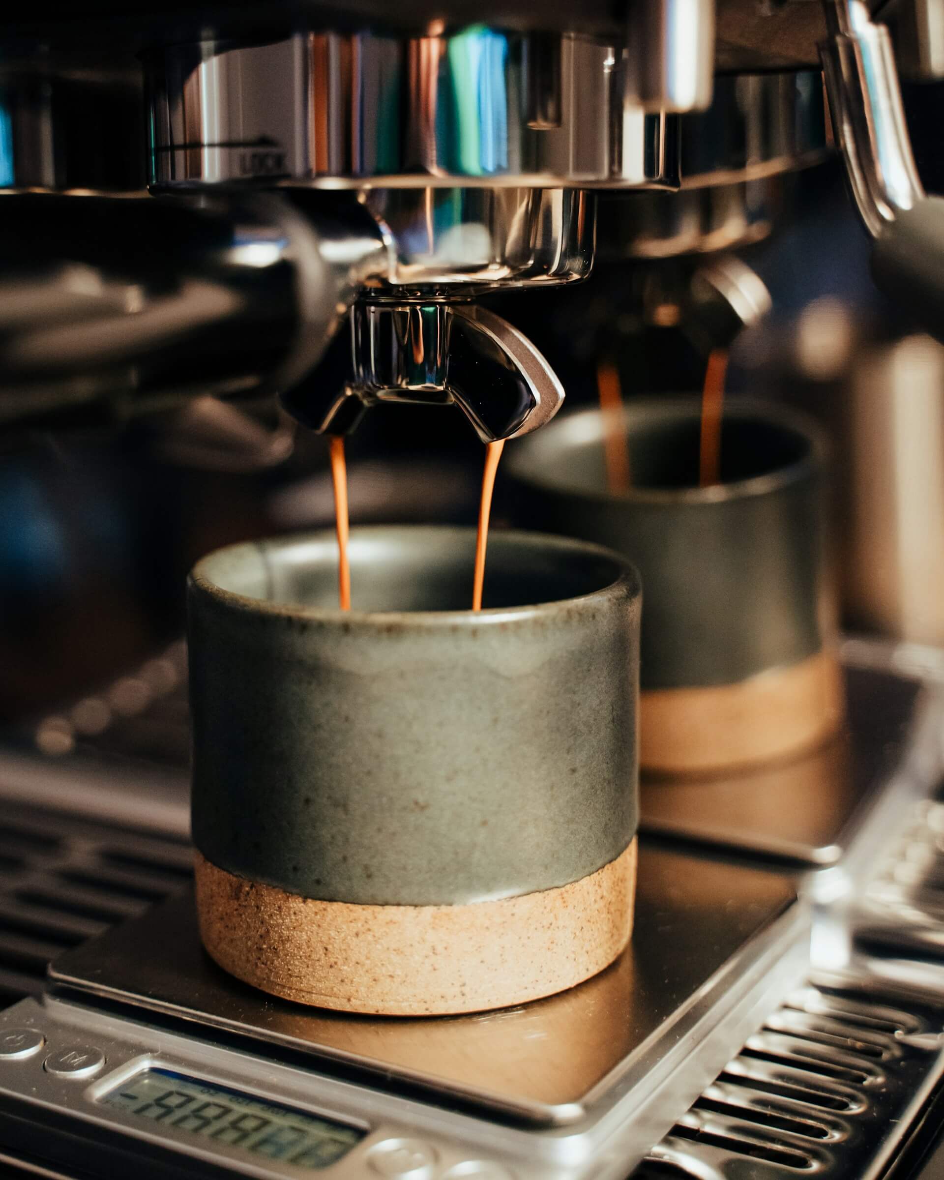 Perfecting the art of coffee extraction: a precise and rewarding process. Photo by <a href="https://unsplash.com/@lukeporter?utm_content=creditCopyText&amp;utm_medium=referral&amp;utm_source=unsplash">Luke Porter</a> on <a href="https://unsplash.com/photos/white-ceramic-cup-on-black-and-silver-coffee-maker-zZfuH4lINlk?utm_content=creditCopyText&amp;utm_medium=referral&amp;utm_source=unsplash">Unsplash</a>